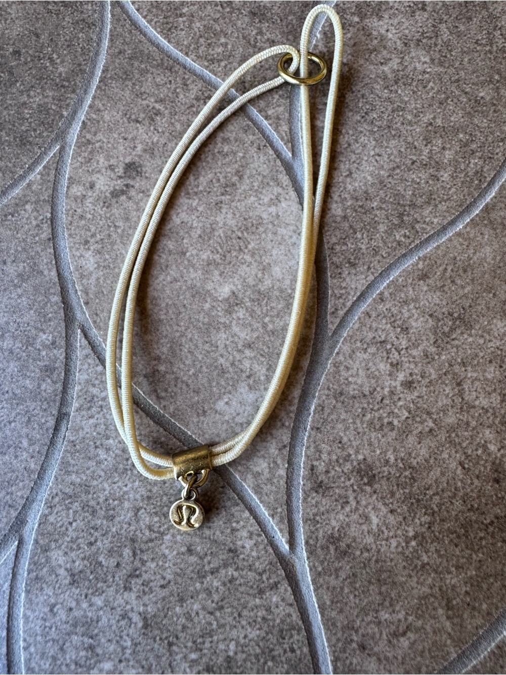 Used Lululemon Logo charm Hair Tie - Pale Linen- excellent condition